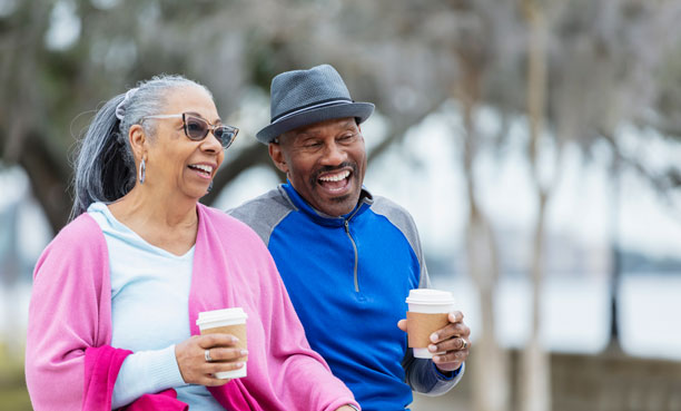 couple walking and having coffee