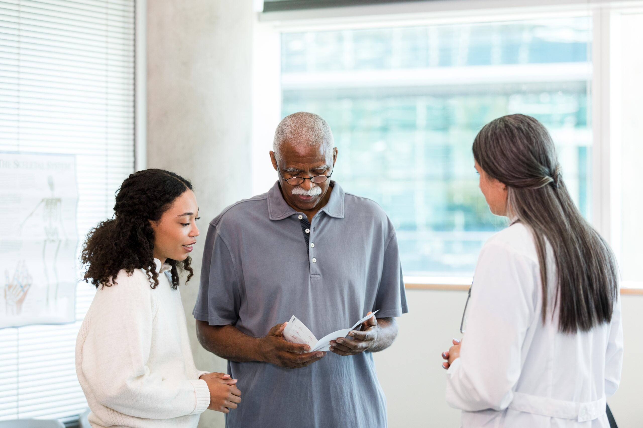 3 people looking at a pamplet