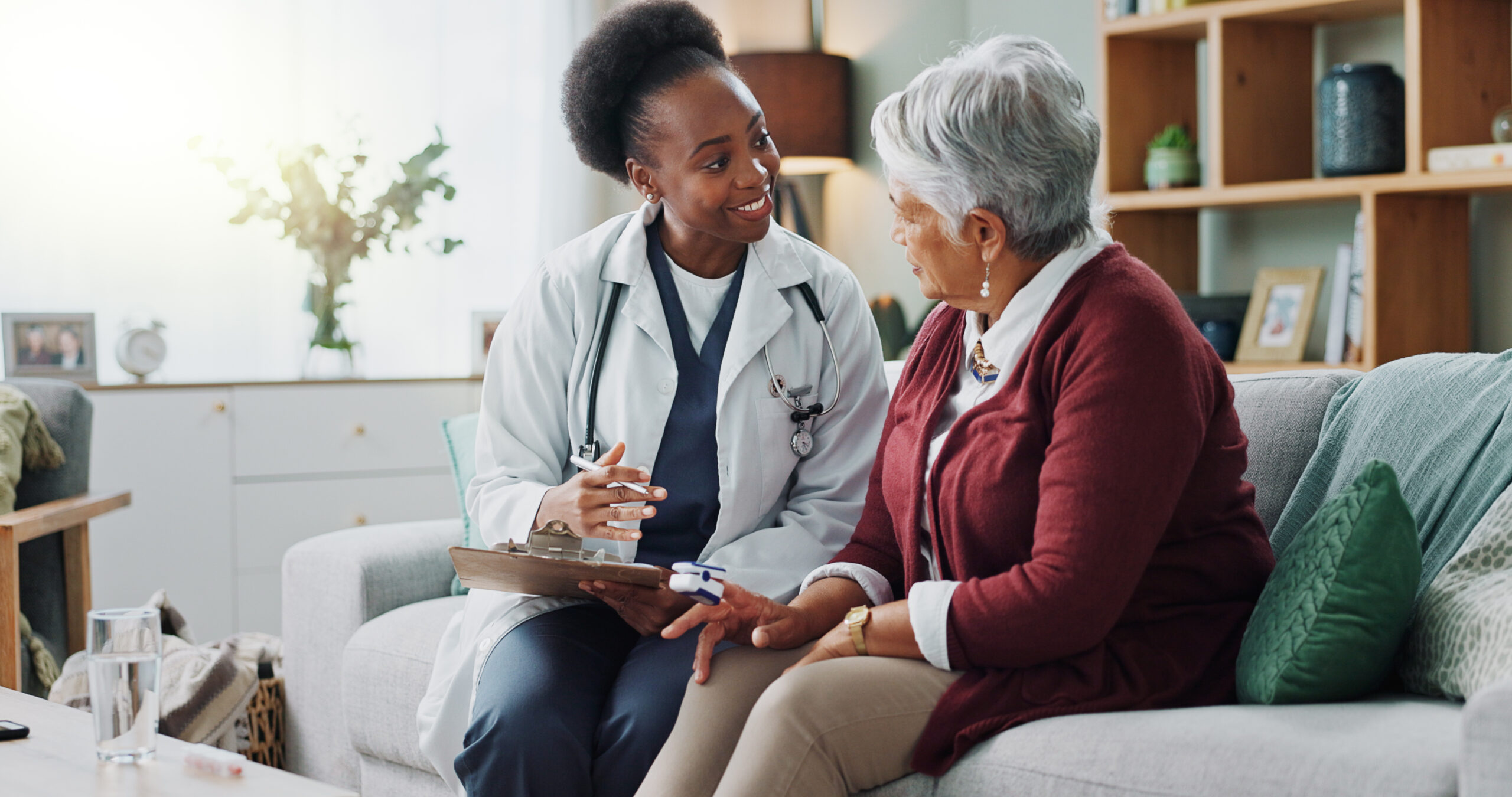 older woman and young nurse sitting